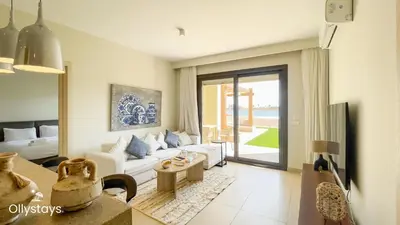 a living room with a couch and a table at Ollystays Shedwan 2 BR Pool & lagoon access in Hurghada