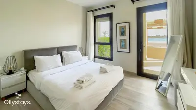 a bedroom with a large bed with towels on it at Ollystays Shedwan 2 BR Pool & lagoon access in Hurghada