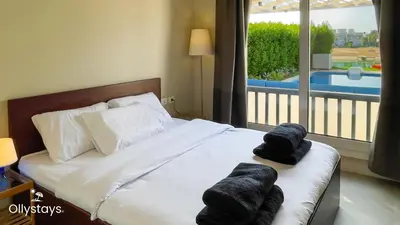 a bedroom with a bed with towels on it at Ollystays Joubal Lagoon 3BR Villa Heated Pool in Hurghada