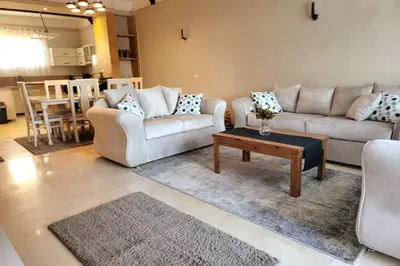 a living room with two couches and a coffee table at Luxury Red Sea Villa in Hurghada
