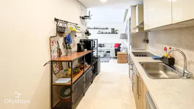 a kitchen with a sink and a counter at Ollystays Mangroovy 2 BR Beach and Pool Free access in Hurghada
