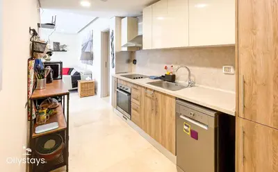 a kitchen with a sink and a stove top oven at Ollystays Mangroovy 2 BR Beach and Pool Free access in Hurghada