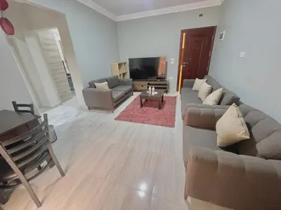 a living room with a couch and a tv at Elegant one bedroom apartment managed by Lilly Homes in Hurghada