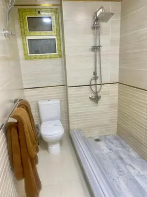 a bathroom with a toilet and a shower at Elegant one bedroom apartment managed by Lilly Homes in Hurghada