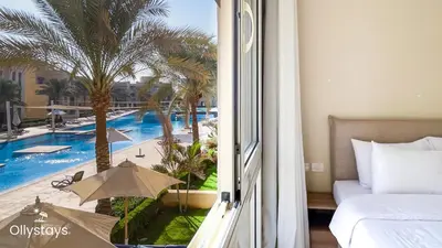 a hotel room with a view of a swimming pool at Ollystays Mangroovy 2 BR Beach and Pool Free access in Hurghada