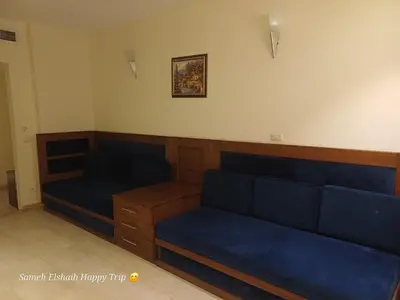 a room with two blue couches in a room at Palma Resort Apartments and Suites with Private Beach in Hurghada