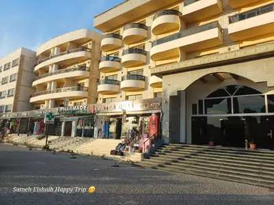 a large building with stairs in front of it at Palma Resort Apartments and Suites with Private Beach in Hurghada