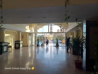 a lobby with people walking through a building at Palma Resort Apartments and Suites with Private Beach in Hurghada