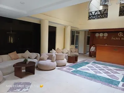 a lobby with couches and a stage in a building at Palma Resort Apartments and Suites with Private Beach in Hurghada