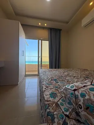 a bedroom with a bed with a view of the ocean at Casablanca star hurghada in Hurghada