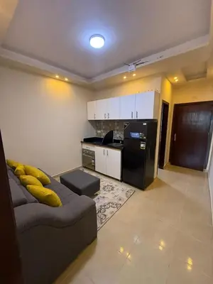a living room with a couch and a kitchen at Casablanca star hurghada in Hurghada