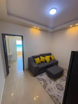 a living room with a couch with yellow pillows at Casablanca star hurghada in Hurghada
