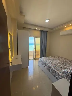 a bedroom with a bed and a view of the ocean at Casablanca star hurghada in Hurghada
