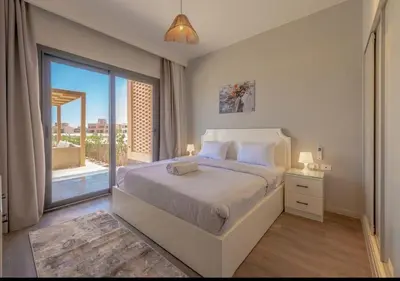 a bedroom with a bed and a large window at Ollystays Ancient Hill 4BR Villa Private Pool in Hurghada