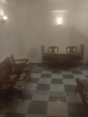 a misty room with chairs and a checkerboard floor at New senger tood in Naj‘ al ‘Amrāb