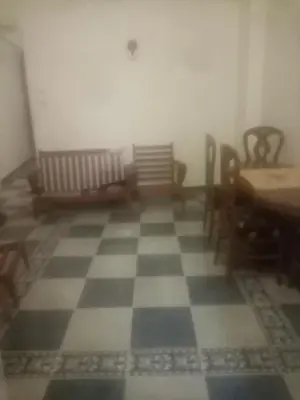 a room with a checkerboard floor with chairs and tables at New senger tood in Naj‘ al ‘Amrāb