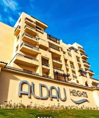 a large building with a sign in front of it at Alday gorizont in Hurghada