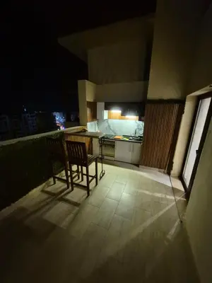 a balcony with a table and chairs and a kitchen at Alday gorizont in Hurghada