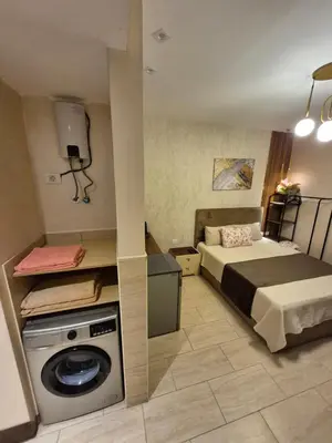 a bedroom with a bed and a washing machine at Alday gorizont in Hurghada