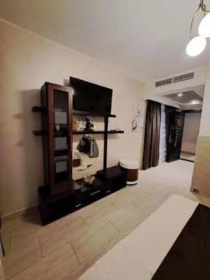 a living room with a tv and a mirror at Alday gorizont in Hurghada