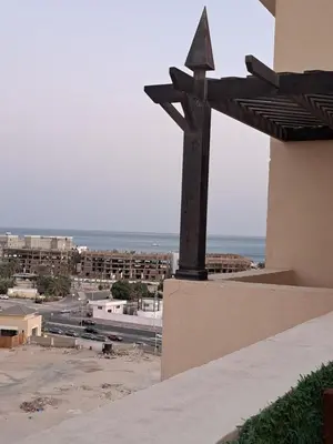 a statue of a cross on the side of a building at Alday gorizont in Hurghada