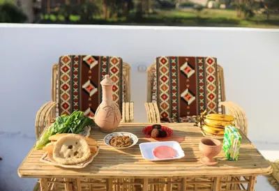 a wooden table with food on top of it at Akhet House in Luxor