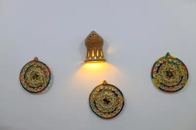 a light fixture with four plates on a wall at Akhet House in Luxor