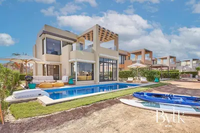 a villa with a swimming pool and two surfboards at BYTK - Casa De Familia in Hurghada