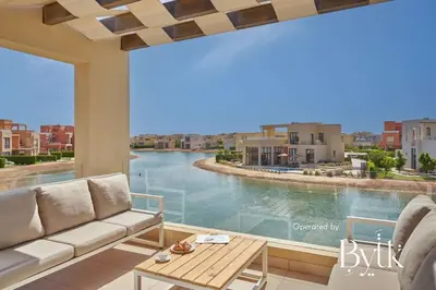 a living room with a couch and a view of a river at BYTK - Casa De Familia in Hurghada