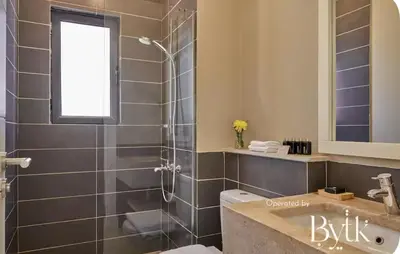 a bathroom with a shower and a toilet and a sink at BYTK - Casa De Familia in Hurghada
