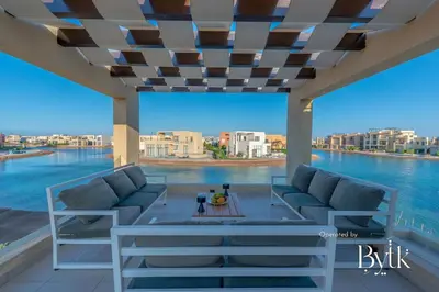 a living room with couches and a view of the water at BYTK - Casa De Familia in Hurghada