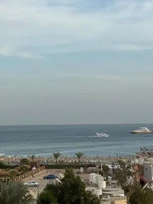 a view of a beach with a cruise ship in the water at Touristic centre beach2 in Hurghada