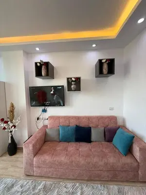 a brown couch in a living room with pictures on the wall at Touristic centre beach2 in Hurghada