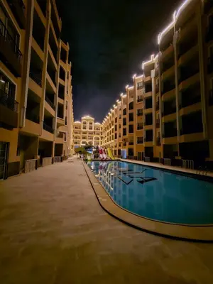 a pool in the middle of a building at night at Juliana beach resort in Hurghada