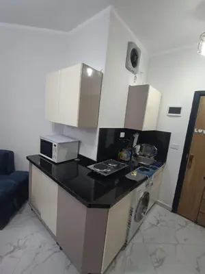 a kitchen with a counter top with a microwave at Juliana beach resort in Hurghada