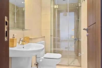 a bathroom with a toilet and a sink and a shower at The G Cribs Sunlit - El Gouna in El Gouna