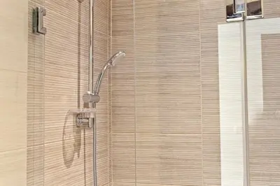 a shower with a shower head in a bathroom at The G Cribs Sunlit - El Gouna in El Gouna