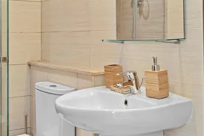 a bathroom with a white sink and a toilet at The G Cribs Sunlit - El Gouna in El Gouna
