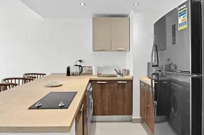 a kitchen with a counter and a refrigerator at The G Cribs Sunlit - El Gouna in El Gouna
