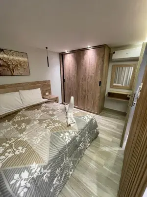 a bedroom with a bed with a stuffed animal on it at New Marina Apartments in Hurghada