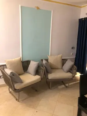 two chairs sitting next to each other in a room at New Marina Apartments in Hurghada