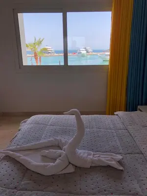 a swan made out of a bed with a window at New Marina Apartments in Hurghada