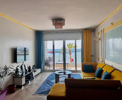 a living room with a couch and a view of the ocean at New Marina Deluxe in Hurghada