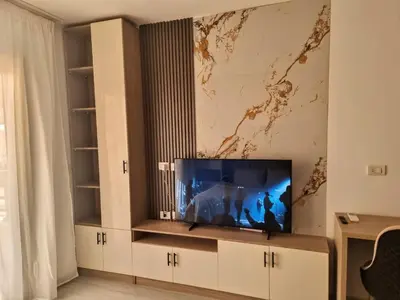 a living room with a flat screen tv on a entertainment center at Oasya Studio Hurghada in Hurghada