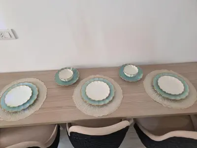 a table with some cups and plates on it at Oasya Studio Hurghada in Hurghada