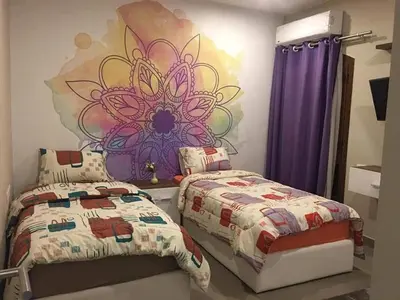 a bedroom with two beds and a mural on the wall at Sabina Comfort Residence in Hurghada
