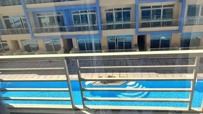 a balcony of a building with a swimming pool at Mirage bay aquapark and resort 110 C minaland in Hurghada