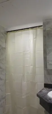a bathroom with a shower curtain and a sink at Mirage bay aquapark and resort 110 C minaland in Hurghada
