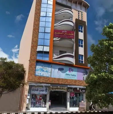 a tall building with a store in front of it at Large Nile View apartment 2 Rooms Air-con Downtown in Aswan