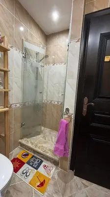 a shower with a glass door in a bathroom at Ferienwohnung Sahl Hasheesh in Hurghada